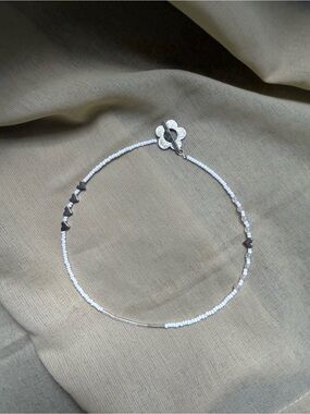 Delicate White Beaded Necklace with Silver Accents and a Flower Toggle Clasp